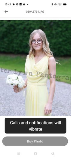 a woman in a yellow dress holding flowers