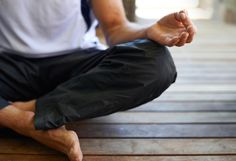 a man sitting on the ground doing yoga