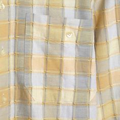 a man is wearing a yellow and blue checkered shirt with buttons on the chest