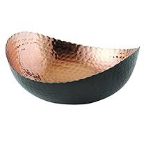 a black and copper bowl on a white background