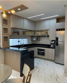 a modern kitchen with stainless steel appliances and marble counter tops