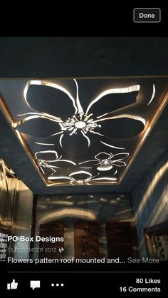 an image of a ceiling with lights in the middle and flowers on it's side