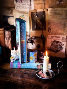 a candle and some books on a table