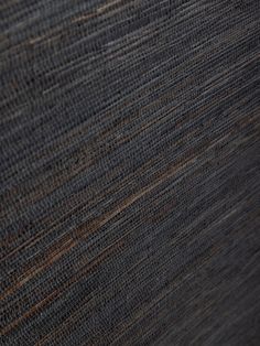 closeup view of the texture of an upholstered fabric material with brown and black stripes