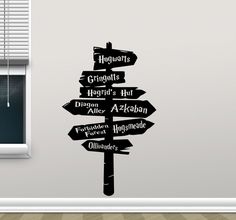 a wall sticker with the words harry potter on it and a sign pointing in different directions