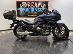 a blue motorcycle is parked in a showroom