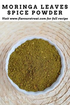 a white bowl filled with green spices on top of a table