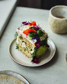 a piece of cake sitting on top of a plate next to a cup and saucer