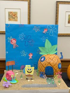 there is a cake made to look like spongebob and pineapples on the table