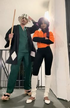 two people dressed in costumes standing next to each other