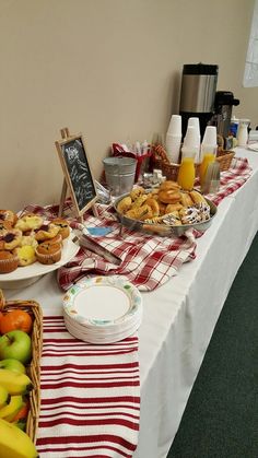 a table topped with lots of food next to a white table cloth covered tablecloth