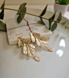 Add a little nature to your looks with these beautiful and delicate long hammered leaf earrings.These earrings are made of high quality brass and have a hand beaten shining texture. These earrings can be worn with jeans and T-shirts,but they would also look great with a dress. They are lightweight and the perfect length for any ear shape. Comes secured by a plastic closure so they will not fall off.  Beautiful in real life Treat yourself with a pair! Customer review: The earrings themselves are Leaf Earrings Gold, Leaf Jewellery, Tropical Jewelry, Nature Earrings, Gold Leaf Earrings, Hammered Earrings, Polymer Crafts, Leaf Jewelry, Delicate Earrings