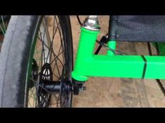 a close up of the front wheel of a green bicycle