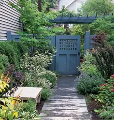 a blue gate in the middle of a garden