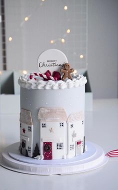 a christmas cake with white frosting and decorations on top, sitting on a plate