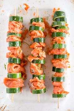 cucumber and salmon skewers on a white plate