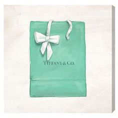 a green shopping bag with a white bow on the front and word tiffany & co