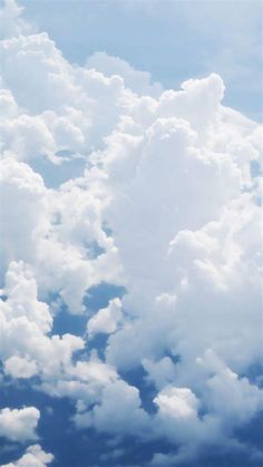 the sky is filled with fluffy clouds and blue skies are visible in the foreground