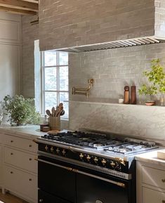 a stove top oven sitting inside of a kitchen