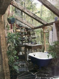 a bathtub and sink in a room with plants