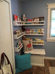 a child's room with bookshelves and stuffed animals on the shelfs