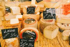 various types of cheese on display in a store