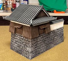 a small model of a house made out of clay