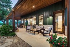 an outdoor living area with patio furniture and lights