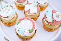 cupcakes decorated with different designs on a plate