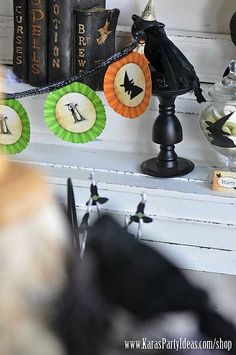 halloween decorations on a shelf with books in the background