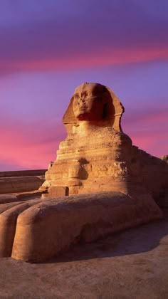 the sphinx statue is in front of a purple sky and pink clouds above it,