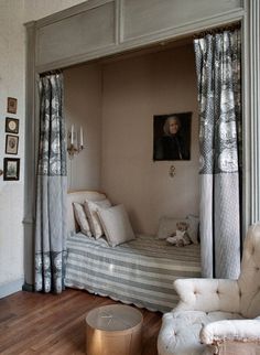 a bedroom with two beds and chairs in it