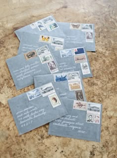 several envelopes with stamps on them sitting on a table