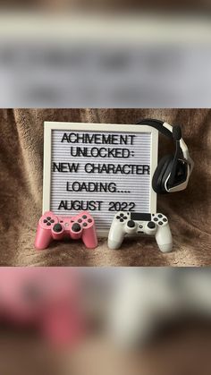 two video game controllers and a sign that says achievement unlocked new character loading august 2012