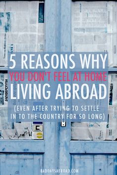 a blue door with the words 5 reasons why you don't feel at home living abroad