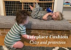 two young children playing with toys in front of a fire place cushion that says, fireplace cushion cost and protection