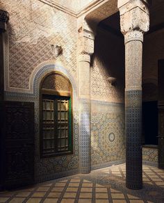 the interior of an old building with columns and tiled walls