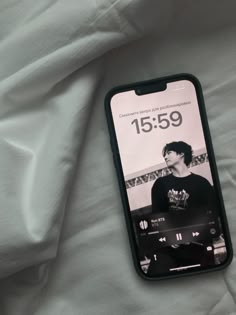 an iphone case sitting on top of a bed with the number fifteen9 printed on it