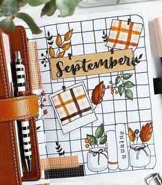 an open notebook with the words september written on it next to some pens and scissors