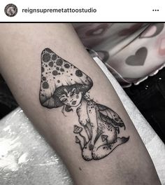 a black and white photo of a woman with a mushroom on her arm