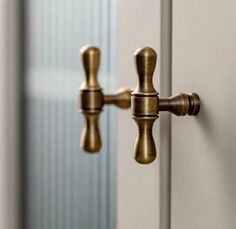 a close up of a door handle on a white door