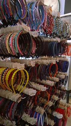 many bracelets are on display in a store