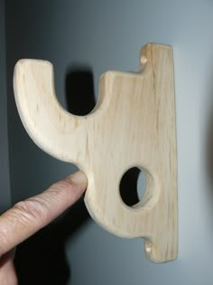 a person is holding a wooden object in their hand