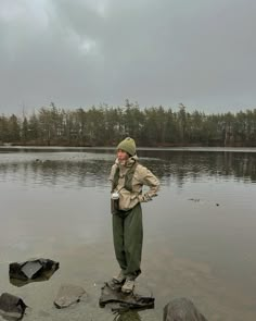 a man standing on rocks in the water