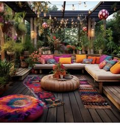 an outdoor living area with lots of plants and rugs on the wooden flooring