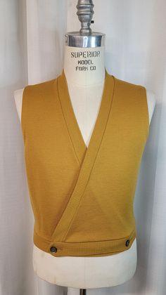 Here for your consideration is this beautiful double breasted sweater vest. Comes in a stunning mustard color with contrasting buttons. Elevate your style with this unique and stylish piece, you will not be disappointed.  When a coat is too much this is all you need, be ready for that special holiday party. Tag reads: None Color Mustard Shoulders- 15"  Chest- 40"  Length- 21"  Approximate Size 38-40 Condition Appears to be in great condition with no apparent or visible issues.  Please view photos as they are part of the description.  All items are vintage and will be described as accurately as possible.  These are not NEW items and therefore, may have some imperfections. Again, I will try to describe items to the best of my knowledge.   Buyer pays all shipping costs. USPS Priority plus ins Double Breasted Vest, Mustard Color, Kilt, Men's Sweater, Costume Design, Sweater Vest, Holiday Party, Too Much, Vintage Men