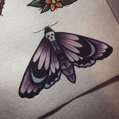 the butterfly is sitting on top of the paper