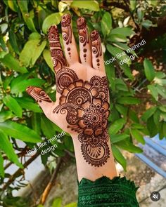 the hand is decorated with henna designs