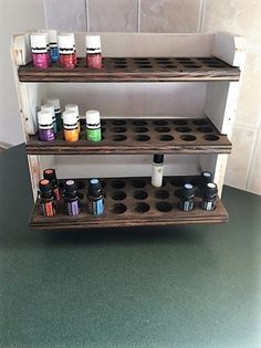 three shelves with different types of paint on them