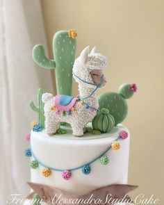 a cake decorated with a llama and cactus